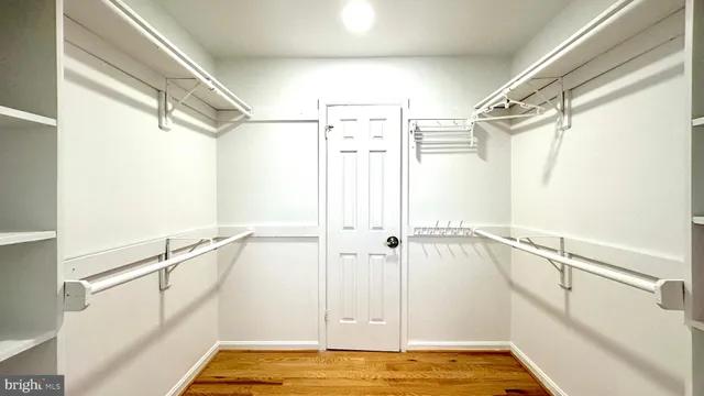 an empty room with wooden floor and a door