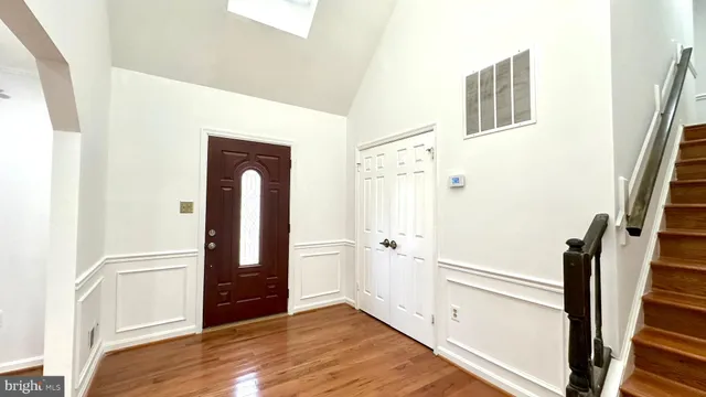 a view of an entryway with wooden floor