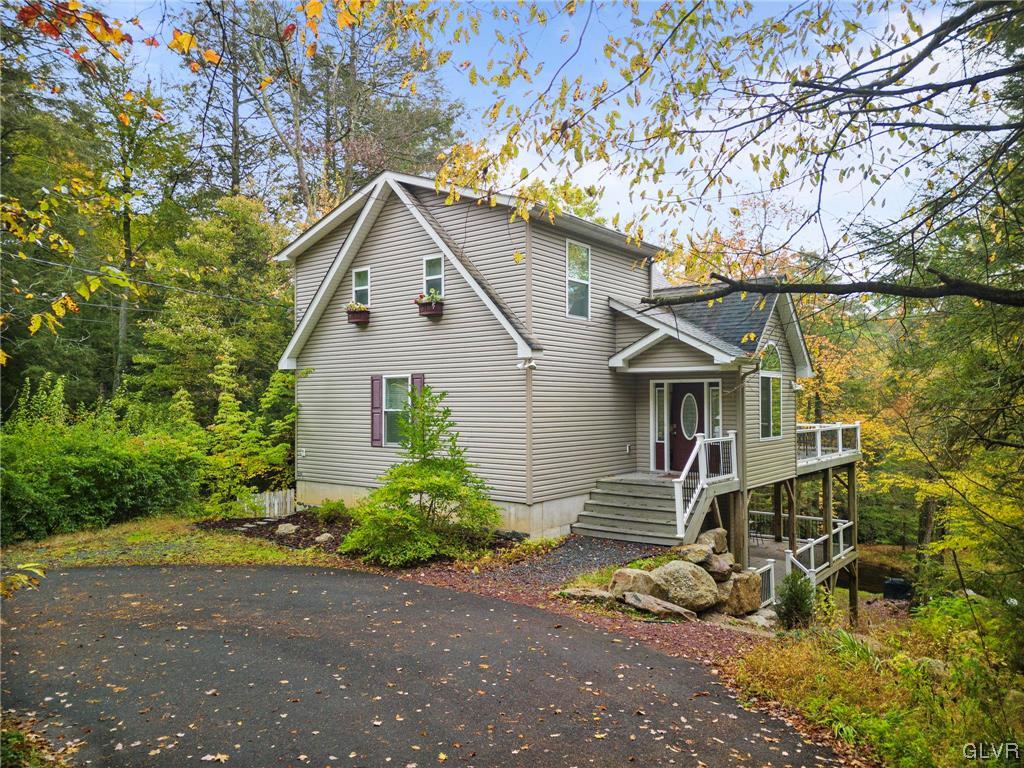 106 Stoney Creek Road Jim Thorpe, PA 18229 - Photo 2 of 50 a view of a house with a small yard plants and large tree