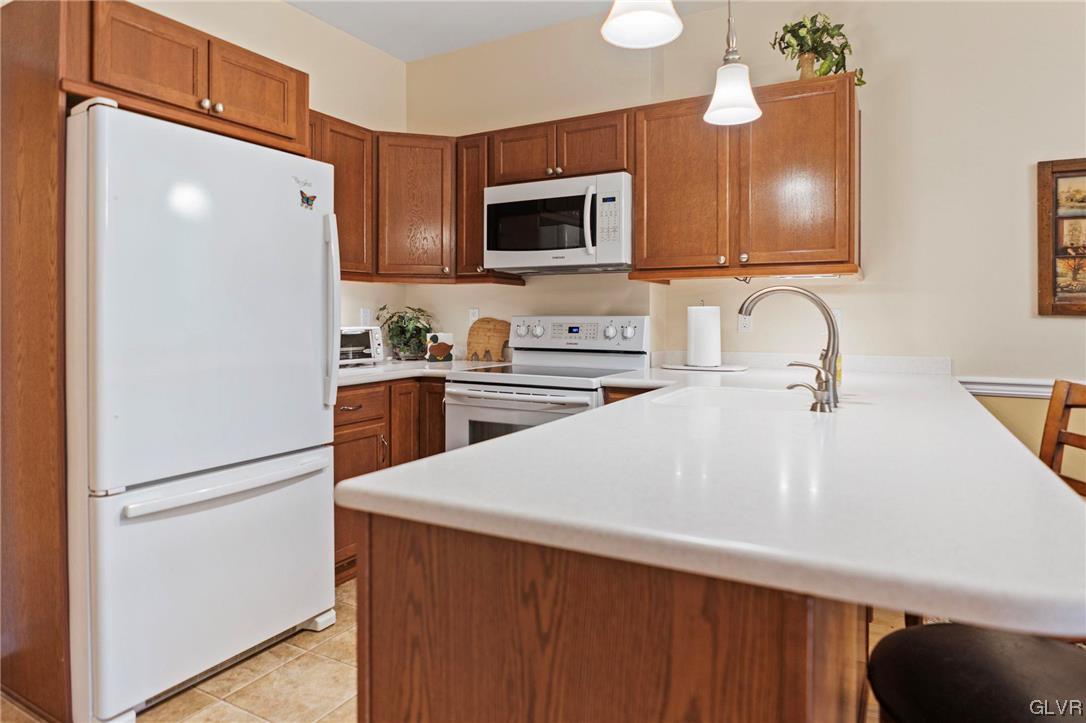 106 Stoney Creek Road Jim Thorpe, PA 18229 - Photo 26 of 50 a kitchen with stainless steel appliances a refrigerator sink and microwave