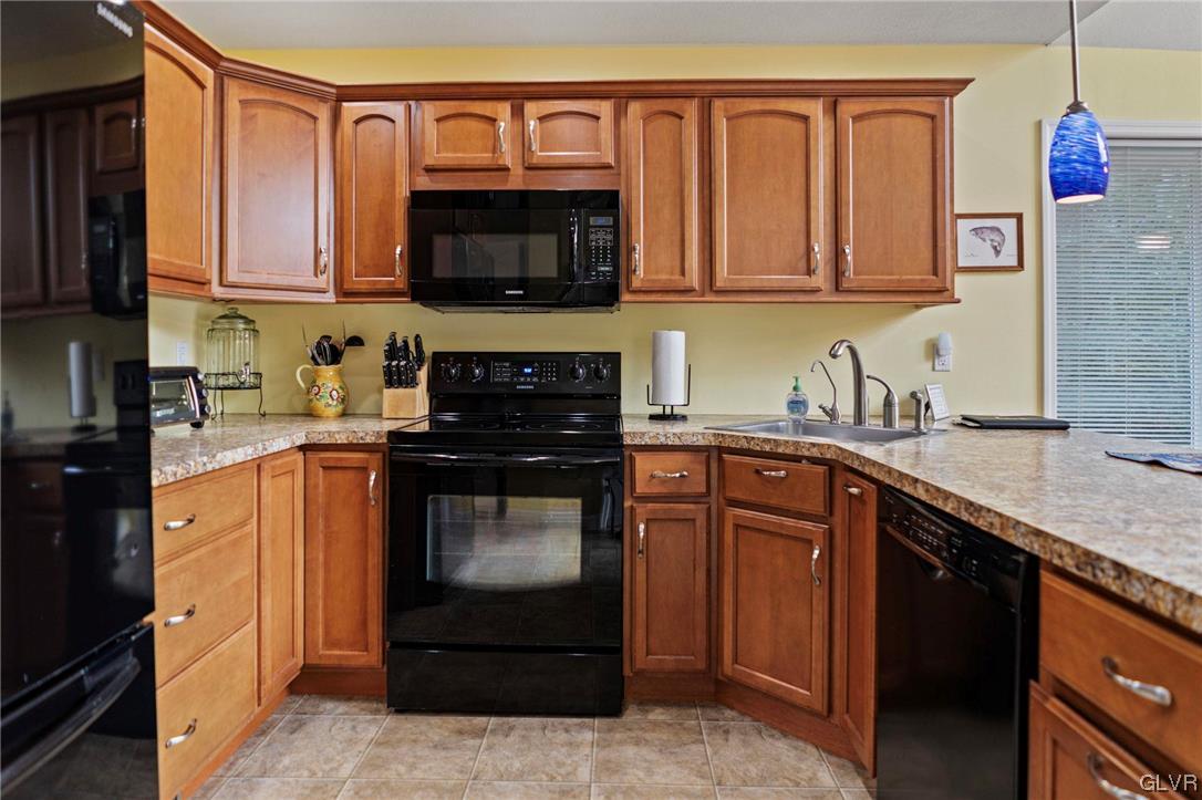 106 Stoney Creek Road Jim Thorpe, PA 18229 - Photo 10 of 50 a kitchen with stainless steel appliances granite countertop a stove top oven a sink dishwasher and a microwave oven with cabinets