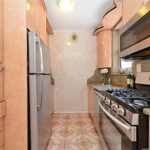 a kitchen with stainless steel appliances granite countertop a stove and a refrigerator