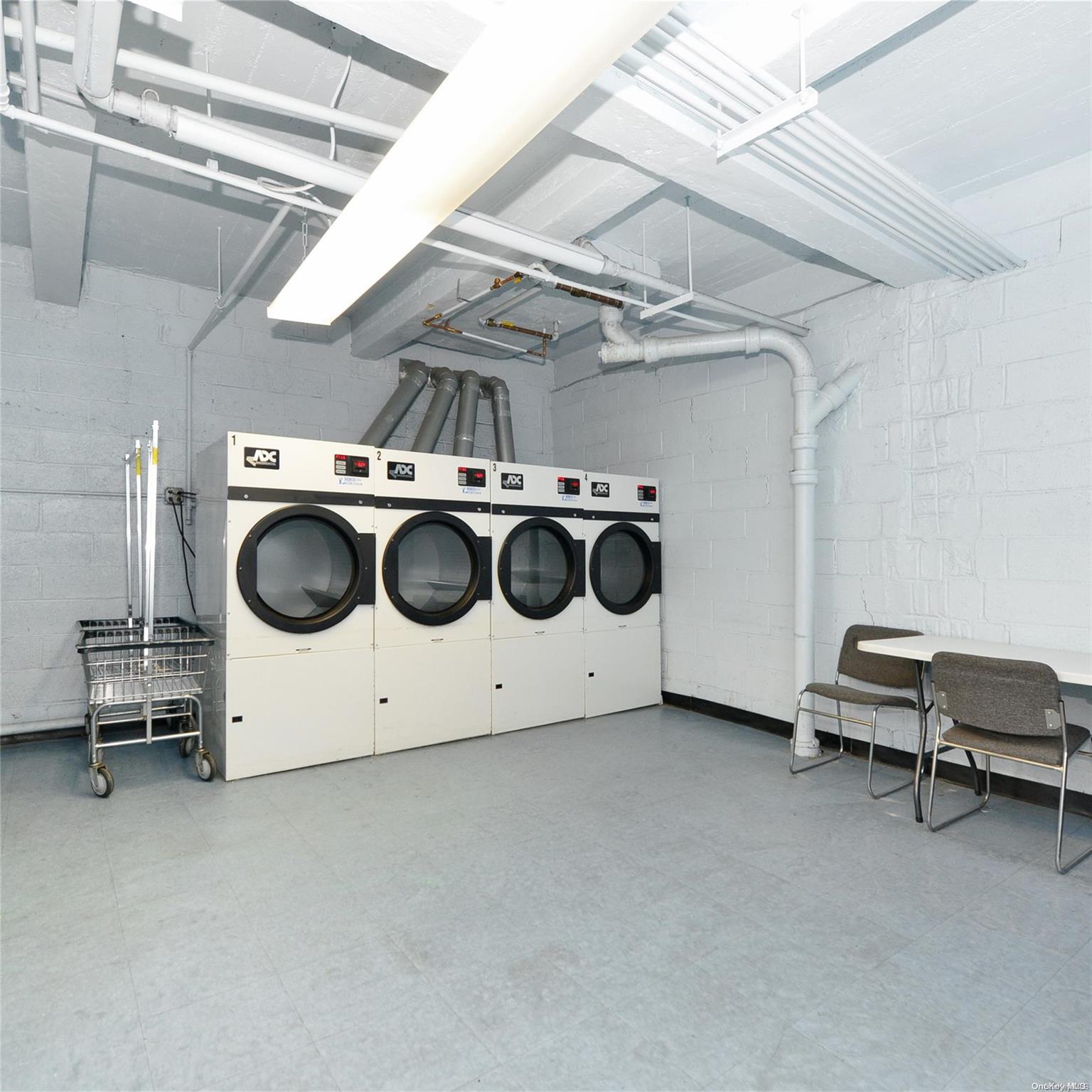 99-15 66th Avenue, Unit 4C Queens, NY 11374 - Photo 15 of 15 a utility room with dryer and washer
