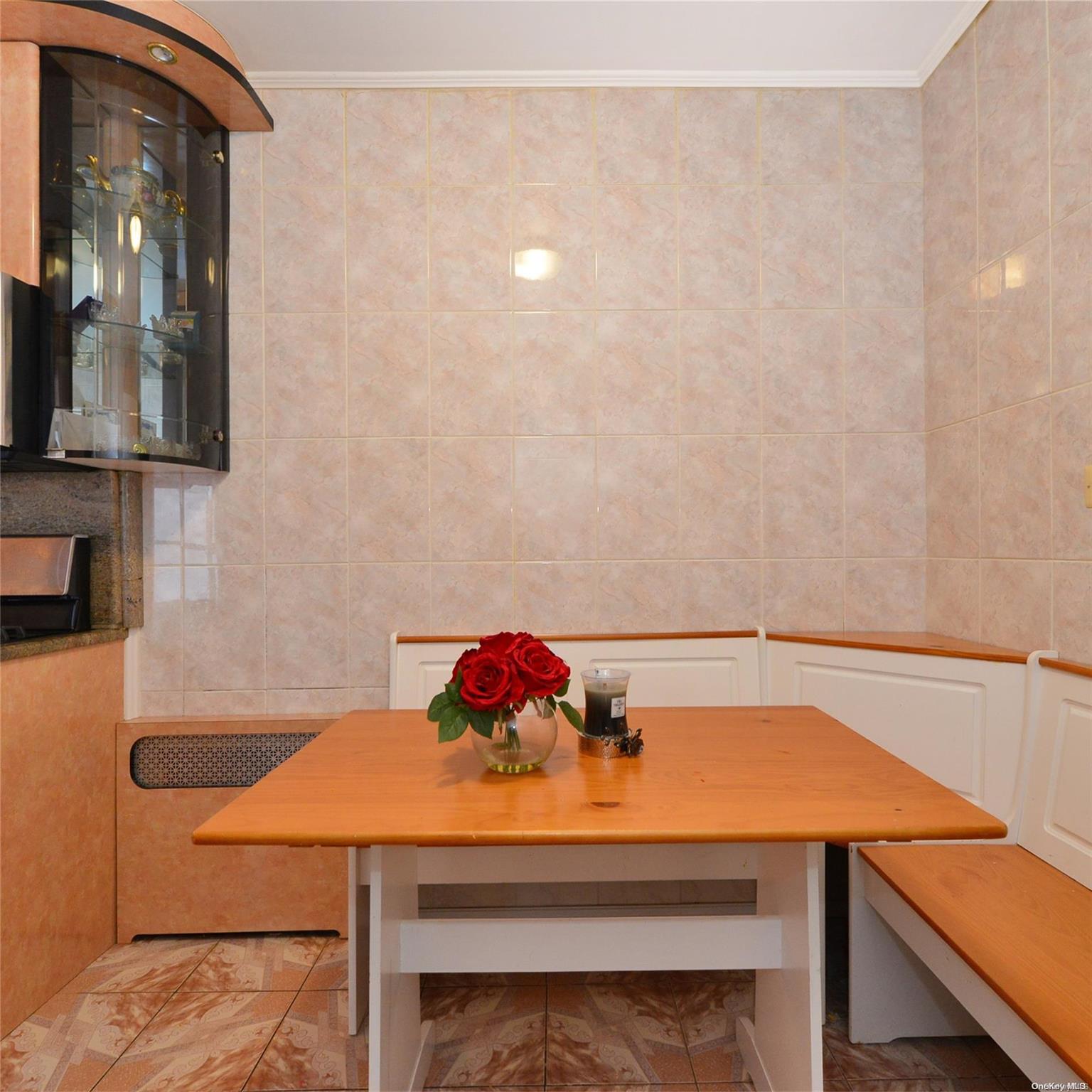 99-15 66th Avenue, Unit 4C Queens, NY 11374 - Photo 10 of 15 a view of a dining room with furniture and wooden floor