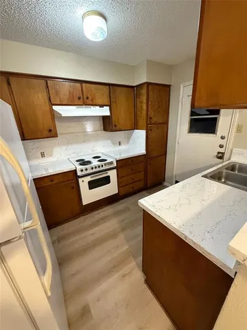 a kitchen with a stove and a refrigerator