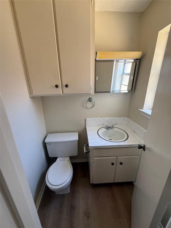 1118 North Nolan River Road, Unit A Cleburne, TX 76033 - Photo 4 of 11 a bathroom with a toilet a sink and a mirror