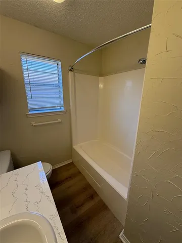 a bathroom with a bathtub and shower