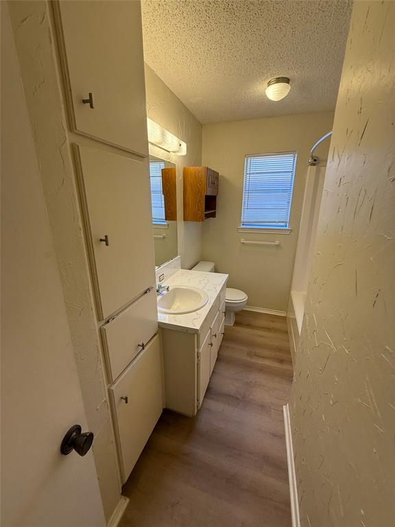 1118 North Nolan River Road, Unit A Cleburne, TX 76033 - Photo 7 of 11 a bathroom with a sink and mirror with bathtub