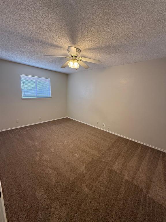 1118 North Nolan River Road, Unit A Cleburne, TX 76033 - Photo 9 of 11 an empty room with a fan & a ceiling fan