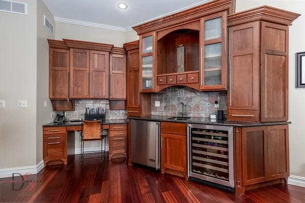 a kitchen with stainless steel appliances granite countertop a stove and cabinets