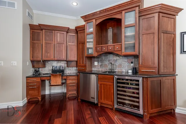 a kitchen with stainless steel appliances granite countertop a stove and cabinets