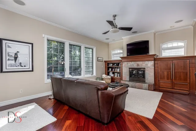 a living room with furniture a flat screen tv and a fireplace