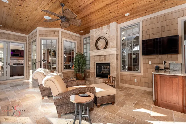 a living room with furniture a flat screen tv and a fireplace