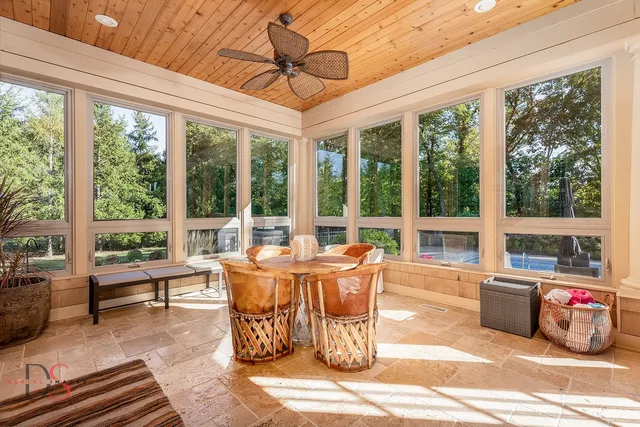 a dining room with furniture water view and a garden