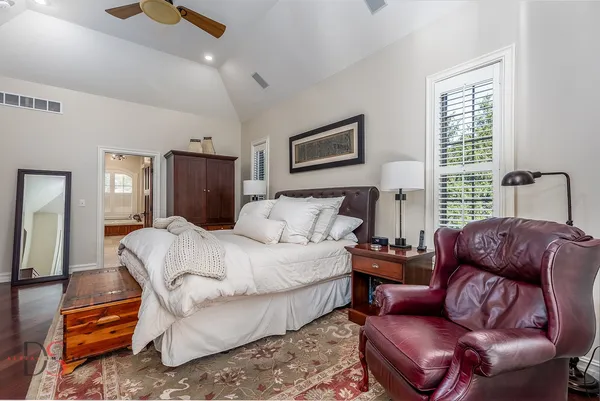 a spacious bathroom with a tub sink and mirror