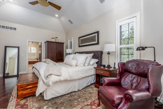 a spacious bathroom with a tub sink and mirror