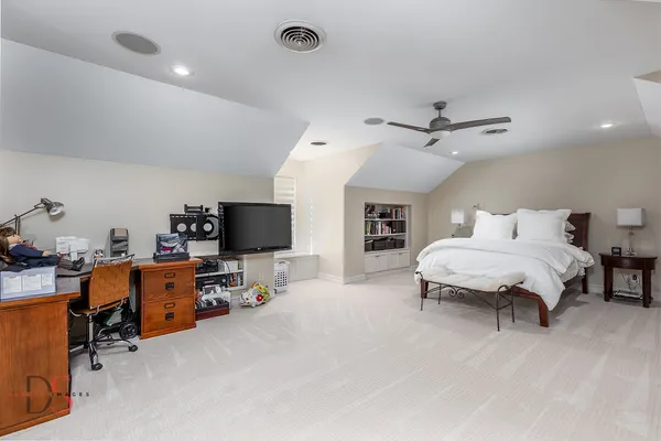 a bedroom with a bed and a wall painting