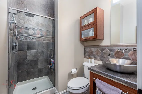 a utility room with stainless steel appliances granite countertop a sink and a washer dryer