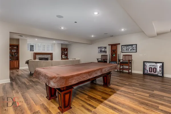 a large kitchen with stainless steel appliances granite countertop a sink and wooden cabinets