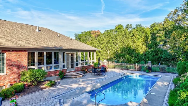 a view of a house with swimming pool and sitting area