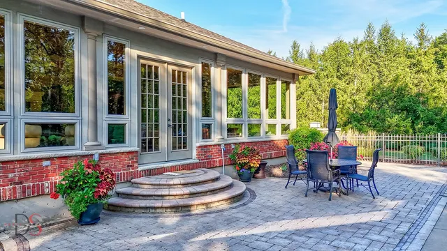 a view of a patio with table and chairs and potted plants