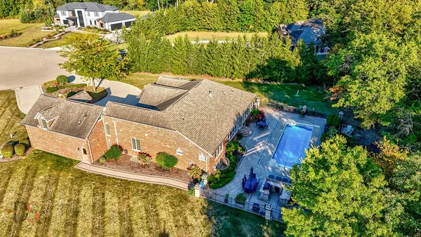 an aerial view of a house with a yard basket ball court and outdoor seating