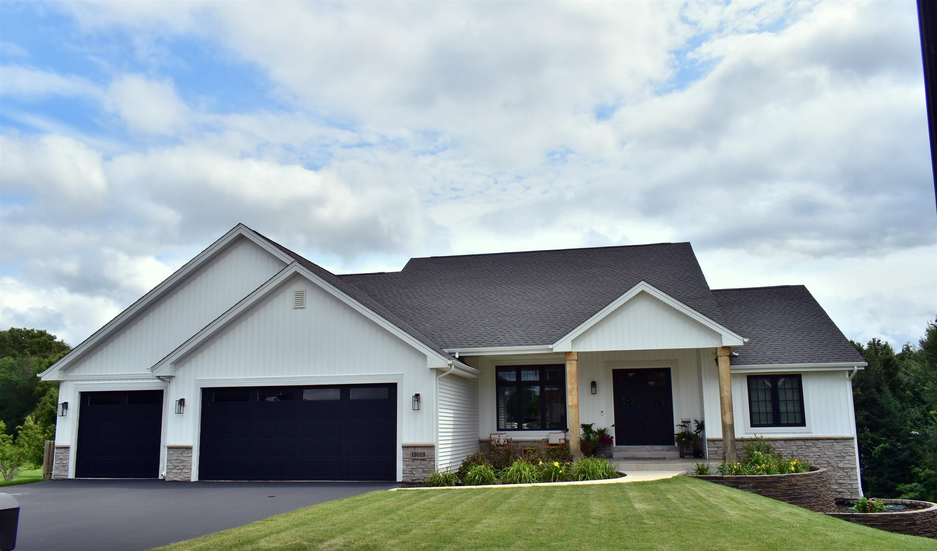 12029 Granite Court Rockton, IL 61072 - Photo 1 of 28 a front view of a house with a garden and yard