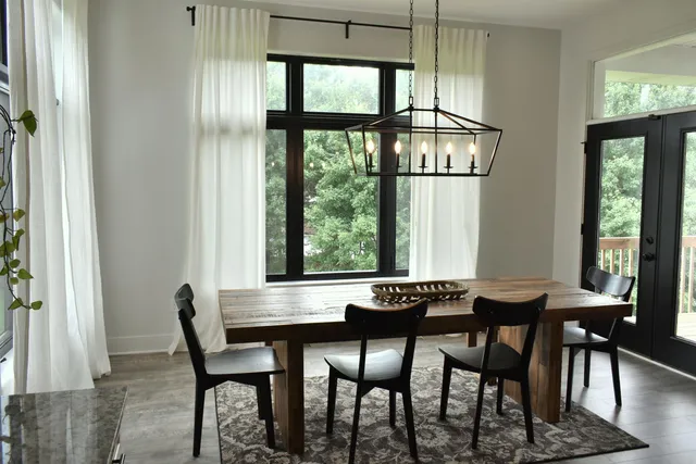 a view of a dining room with furniture and a window