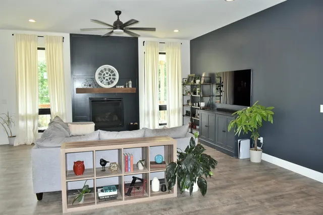 a living room with furniture and a fireplace