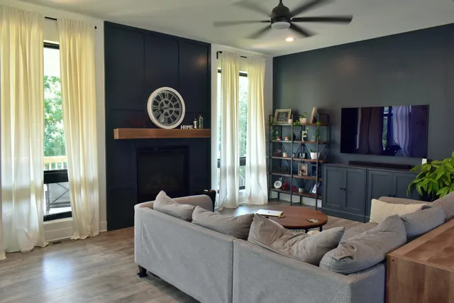 a living room with furniture and a fireplace
