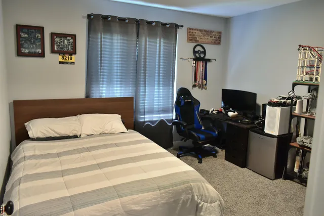 a bedroom with a bed and a television