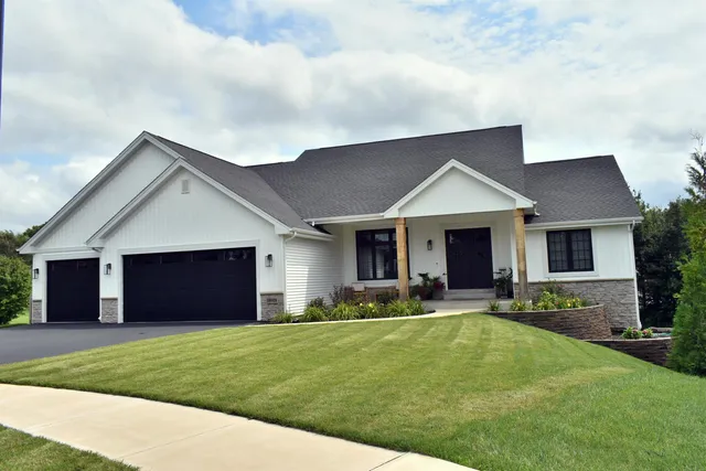 a front view of house with yard and garage