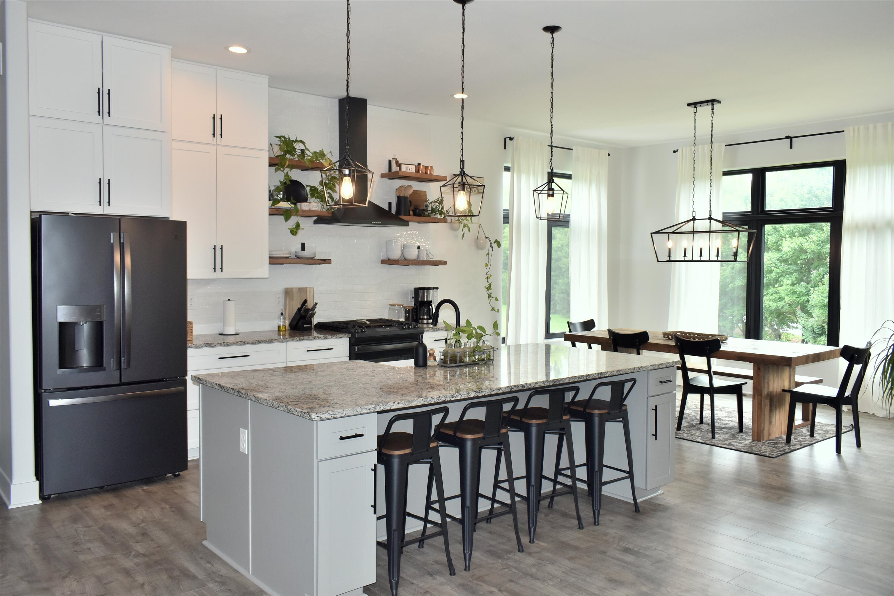 12029 Granite Court Rockton, IL 61072 - Photo 6 of 28 a kitchen with stainless steel appliances granite countertop a dining table chairs refrigerator a sink and a stove