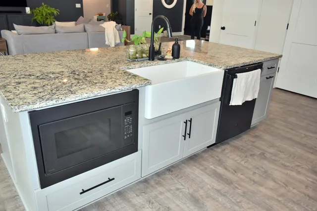 a kitchen with sink and microwave
