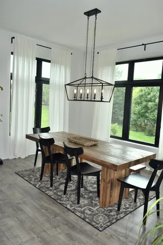 a view of a dining room with furniture window and wooden floor