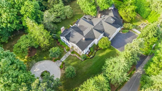 an aerial view of a house with garden space and a street view