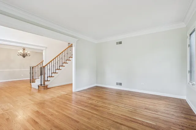 a view of a livingroom with wooden floor and large windows