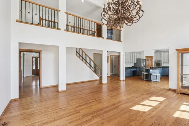 a kitchen with refrigerator and chairs