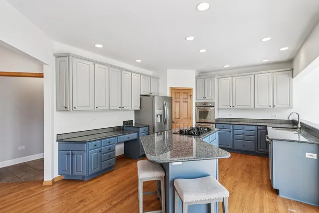 a kitchen with a stove a sink and a refrigerator