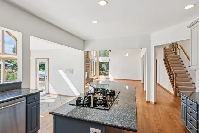 a kitchen with stainless steel appliances granite countertop a stove a sink and a refrigerator