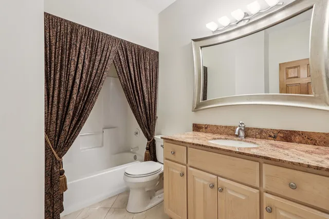 a view of a livingroom with a ceiling fan and window