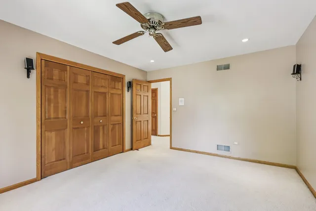 a spacious bathroom with a tub double sink and mirror
