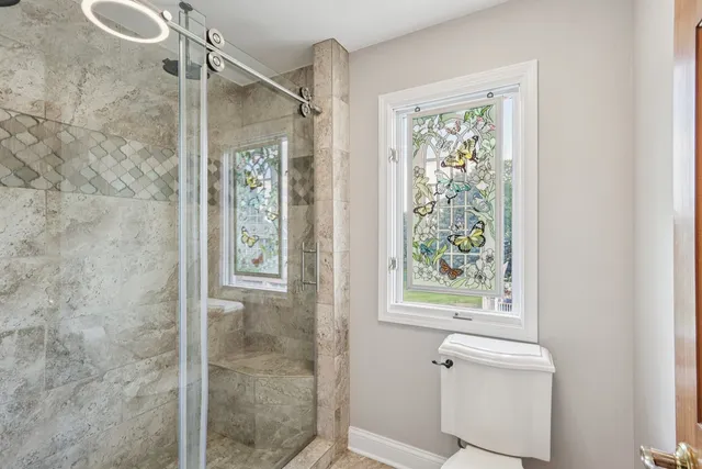 a front view of a house with a yard and potted plants