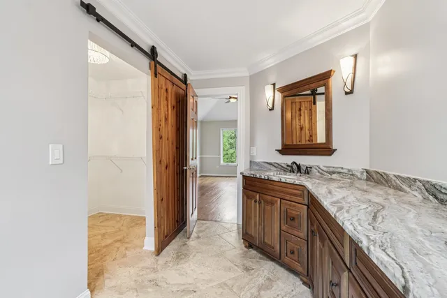 a front view of a house with garden and sitting area