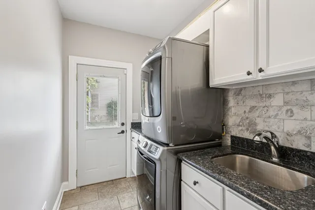 a view of a backyard with plants and tree