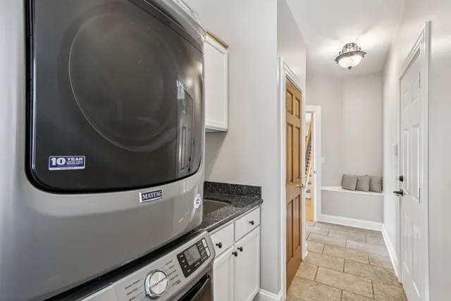 a view of a house with a big yard and large trees