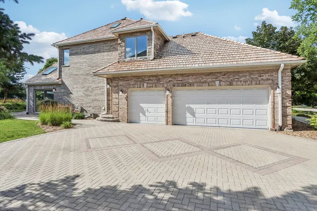 an aerial view of a house with a yard and greenery