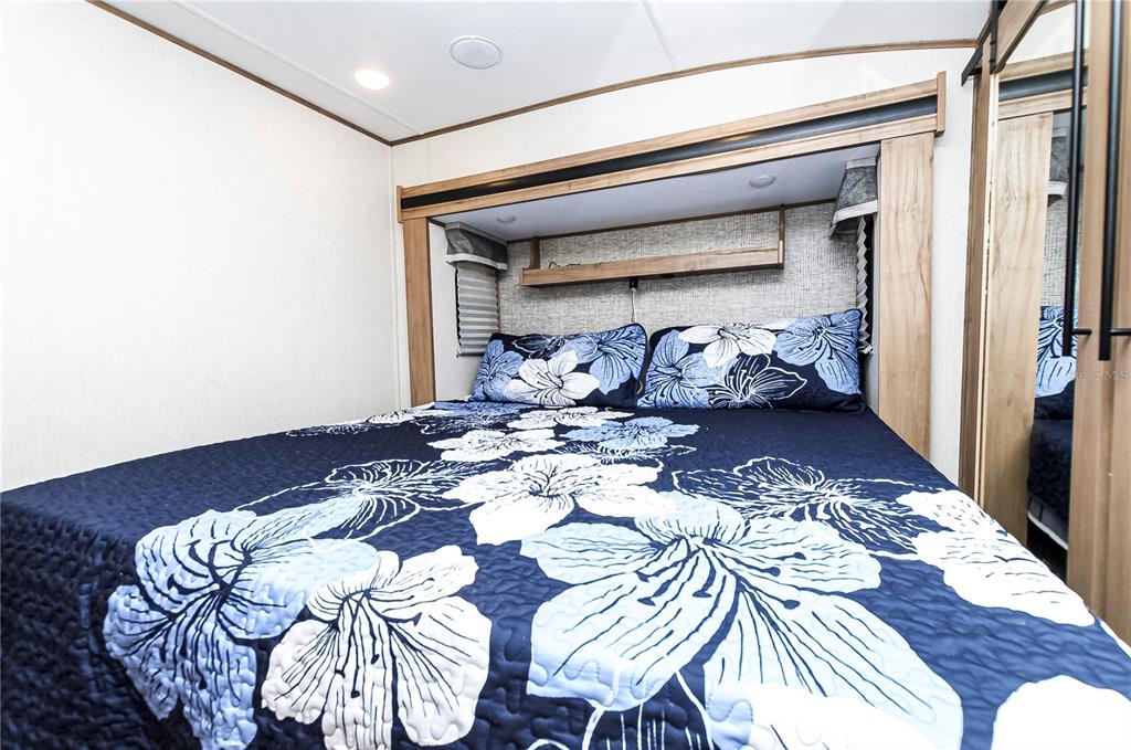 18233 185th Road Live Oak, FL 32060 - Photo 19 of 99 a bed sitting in a bedroom next to a window