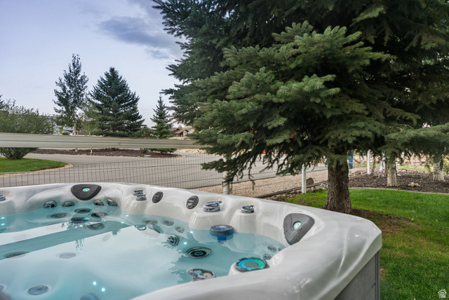 8650 Redden Road Park City, UT 84098 - Photo 42 of 71 Outdoor spa with integrated lighting, surrounded by mature trees and manicured lawn