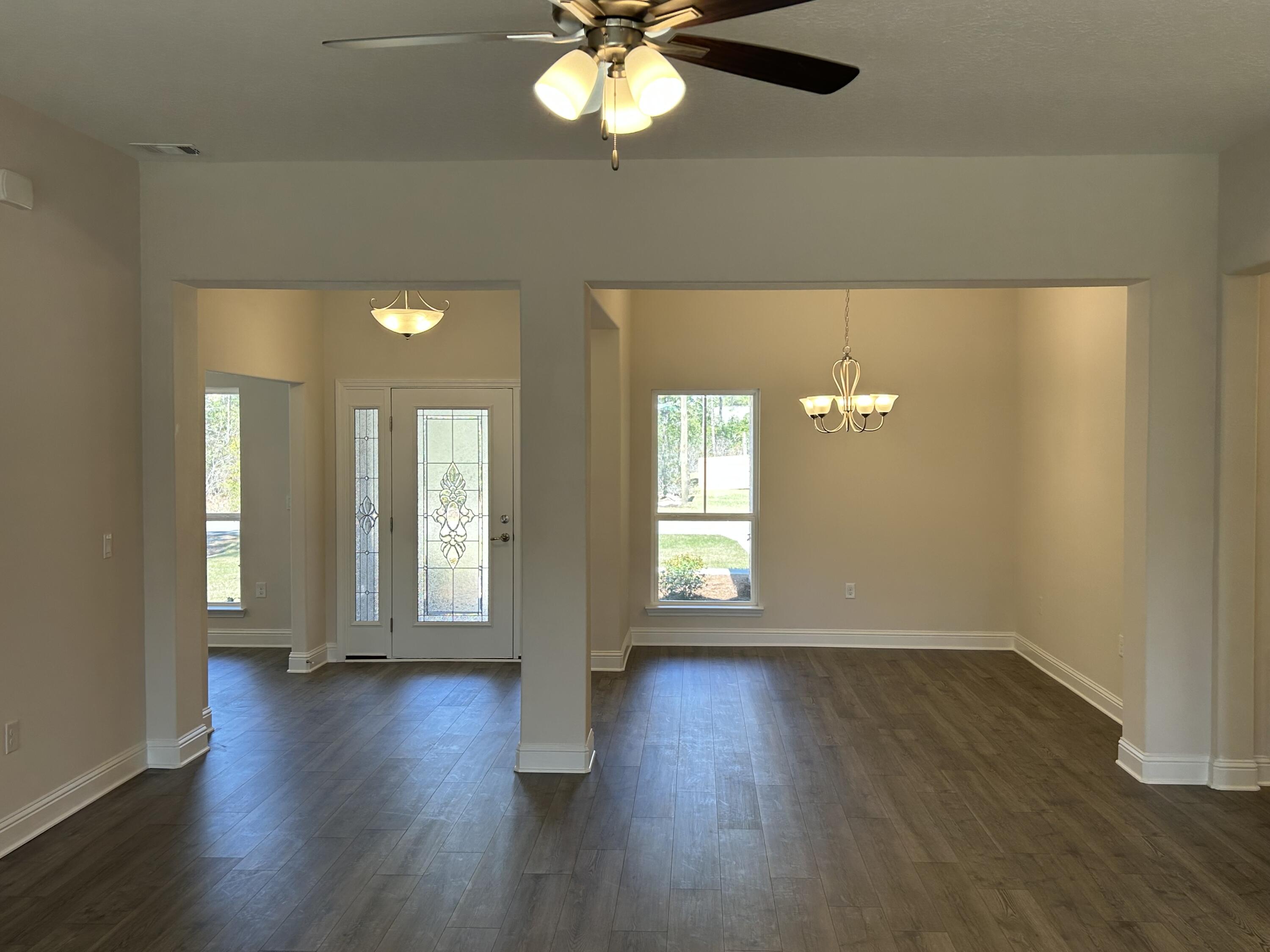 6615 Angle Road, Unit HBTS 5112 Navarre, FL 32566 - Photo 11 of 36 an empty room with wooden floor and windows